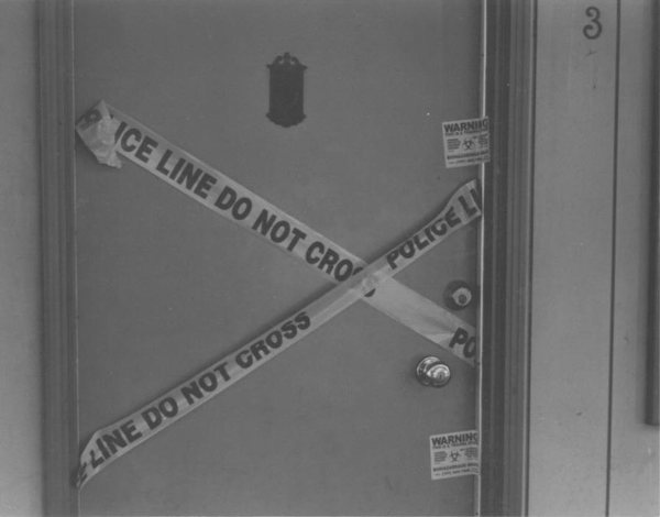 Police tape making an 'X' on the door